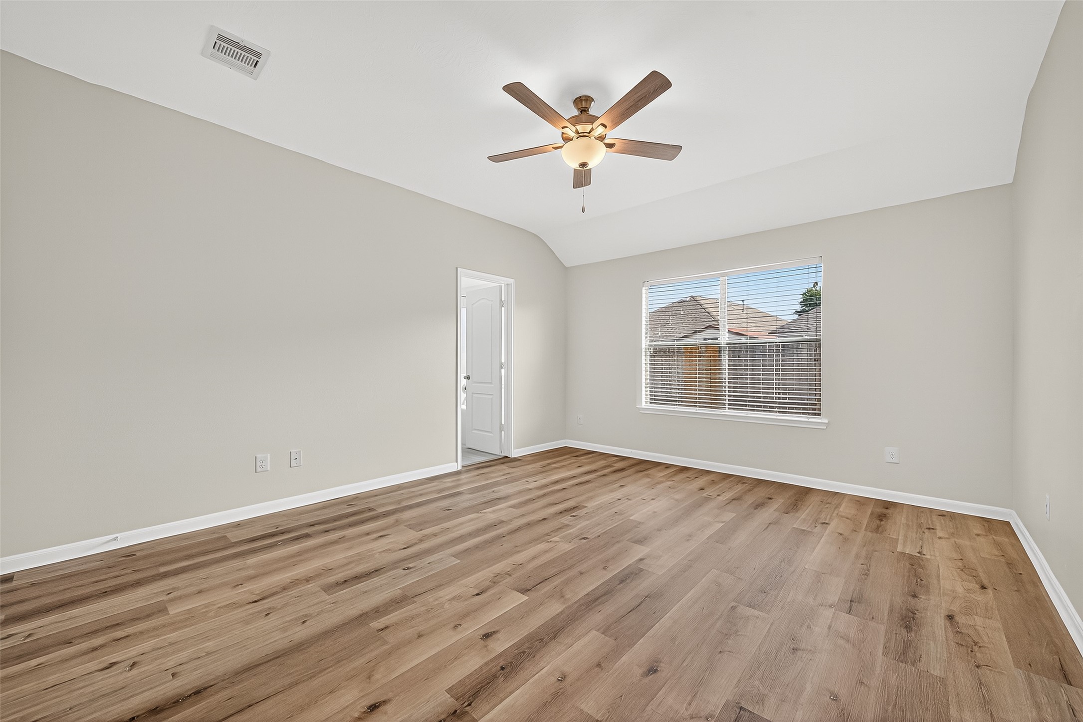 3114 Sabine Spring Lane Katy, TX 77449 - Photo 17 of 34 a view of an empty room with wooden floor and a window