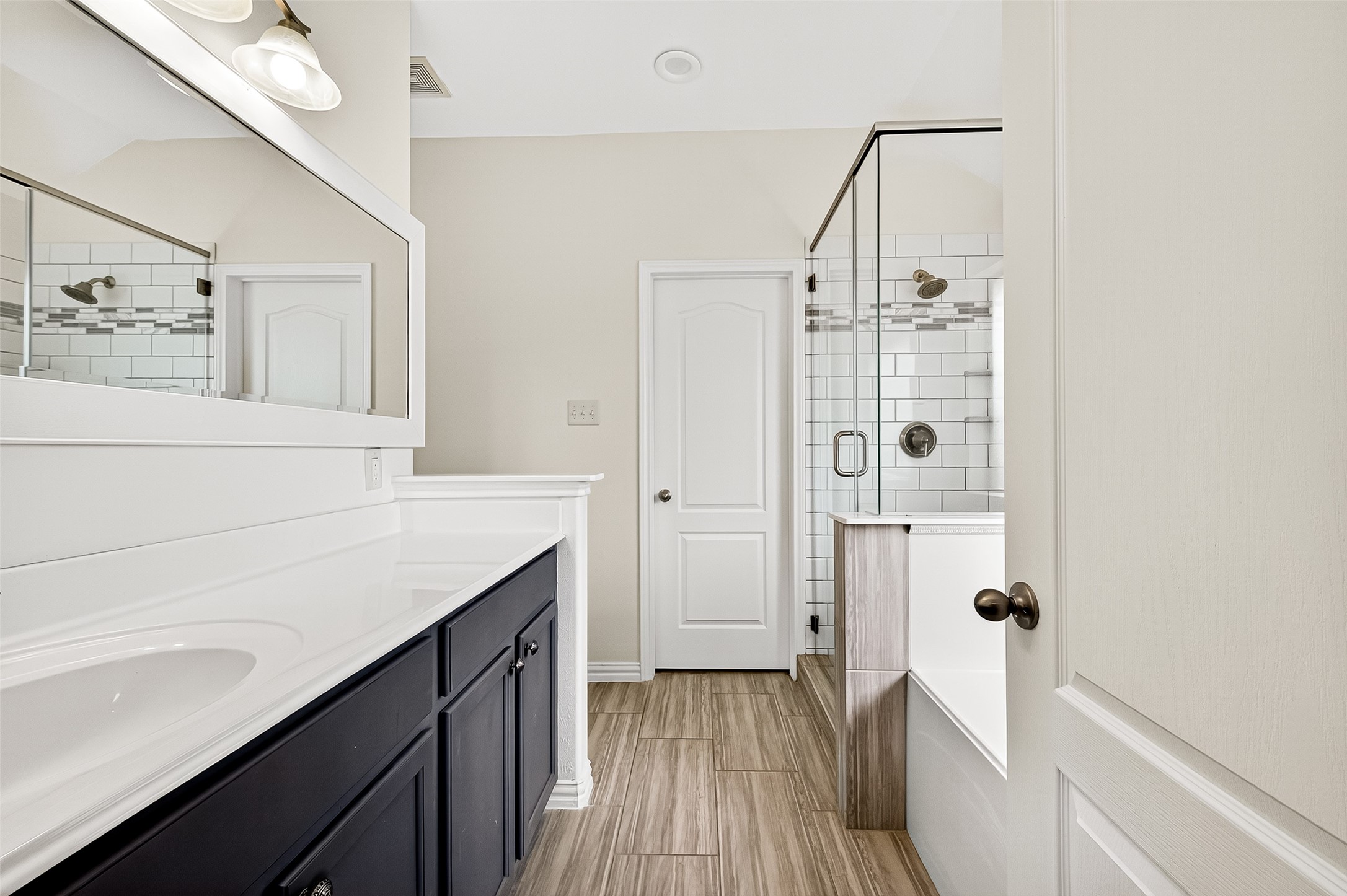 3114 Sabine Spring Lane Katy, TX 77449 - Photo 20 of 34 a bathroom with a sink a mirror and shower