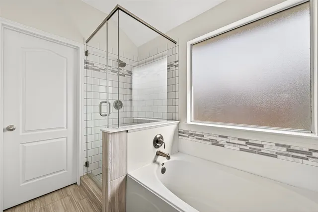 a bathroom with a bathtub and a shower