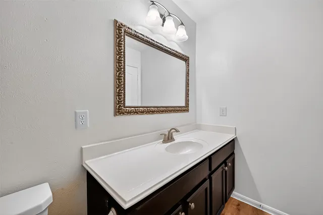 a bathroom with a sink vanity and a mirror