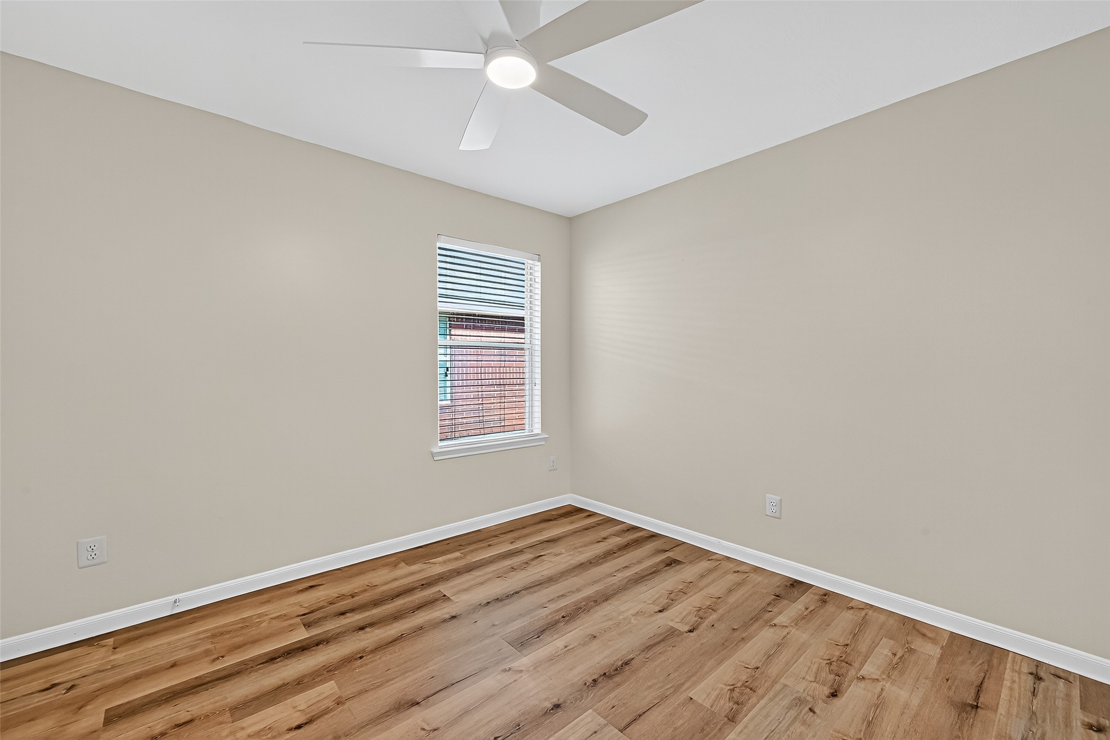 3114 Sabine Spring Lane Katy, TX 77449 - Photo 30 of 34 an empty room with wooden floor fan and windows