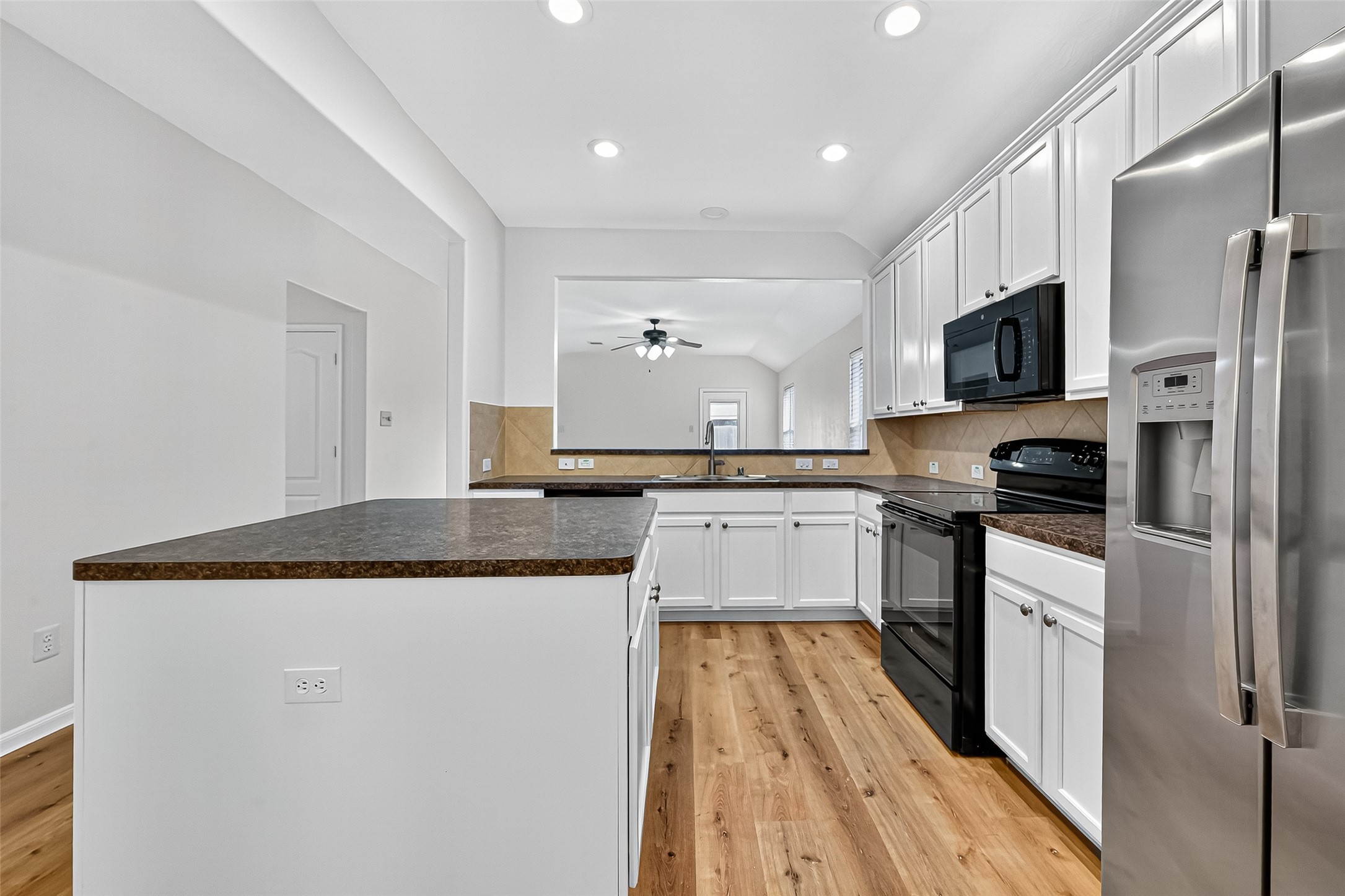 3114 Sabine Spring Lane Katy, TX 77449 - Photo 7 of 34 a kitchen with granite countertop a sink stove and refrigerator