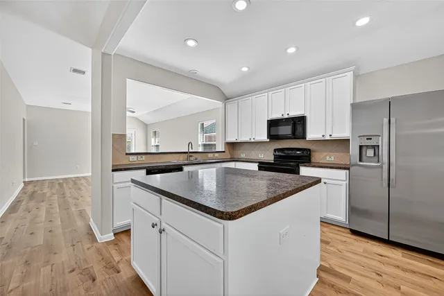 a kitchen with a sink stove and refrigerator