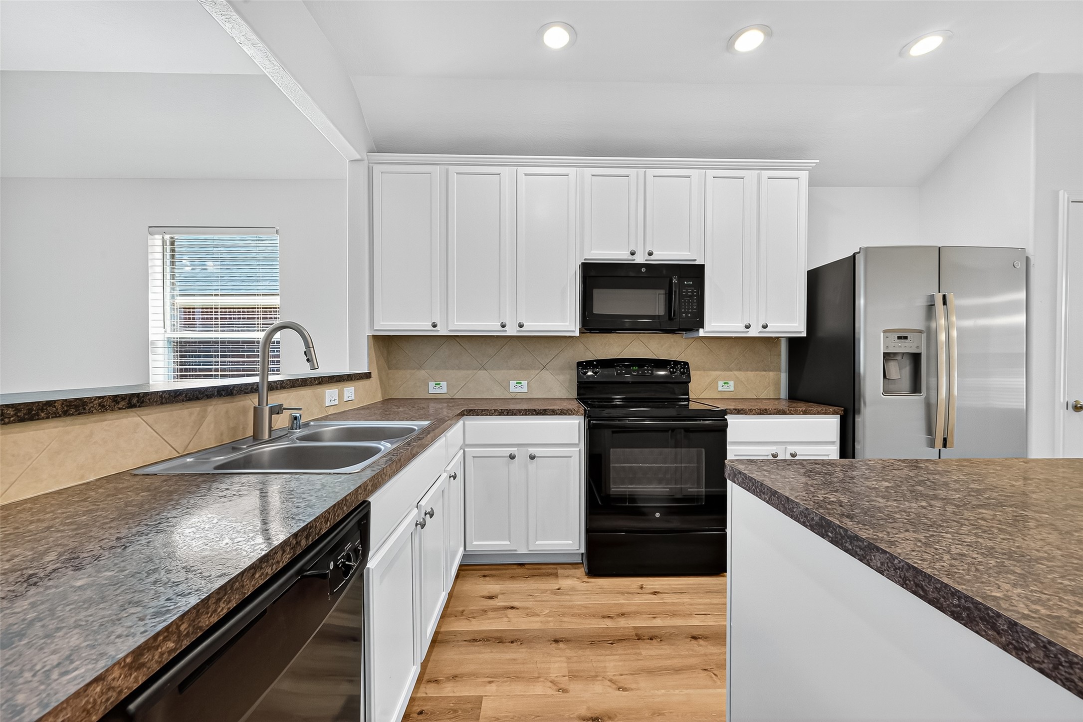 3114 Sabine Spring Lane Katy, TX 77449 - Photo 9 of 34 a large kitchen with granite countertop a sink dishwasher stove and refrigerator