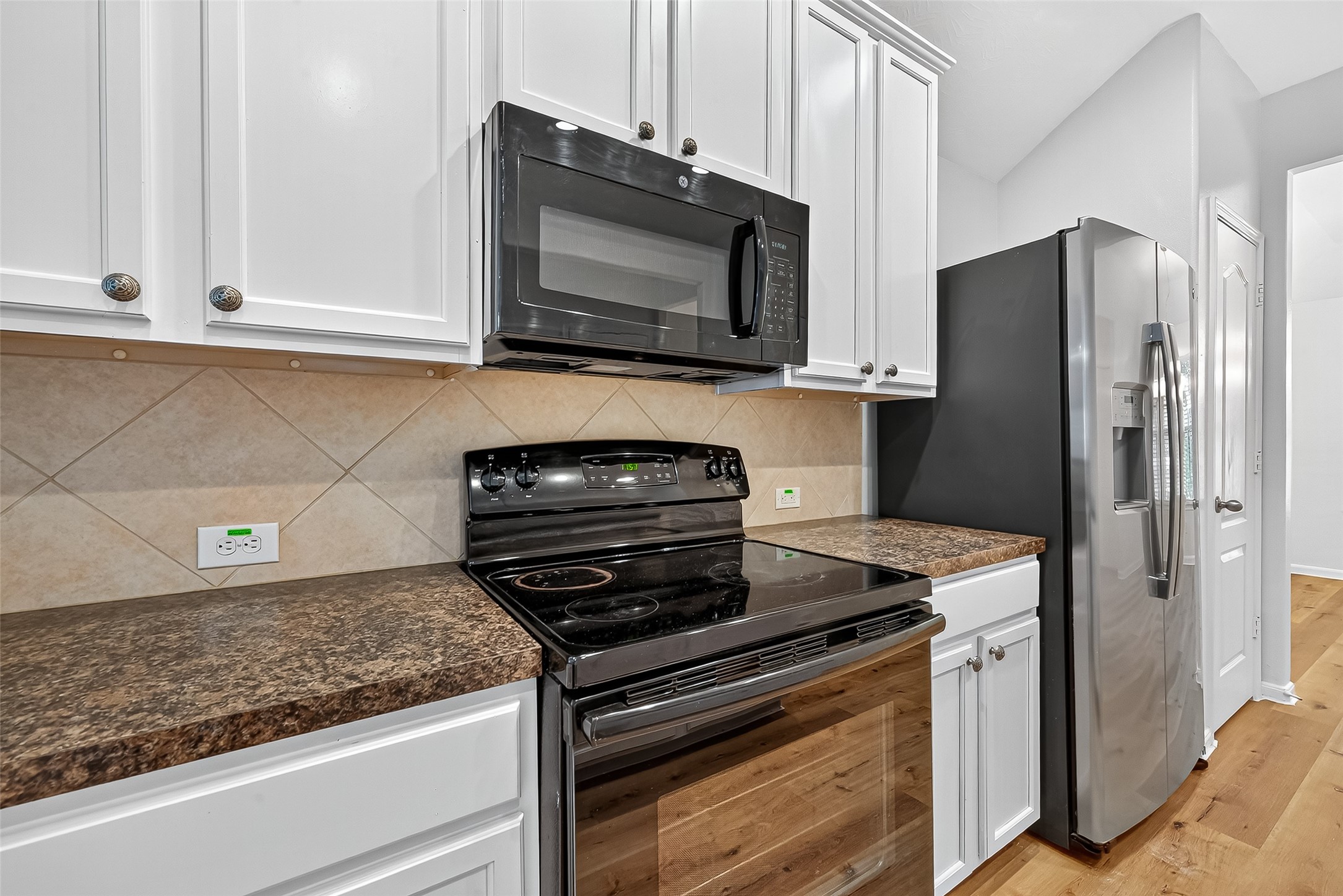 3114 Sabine Spring Lane Katy, TX 77449 - Photo 10 of 34 a kitchen with granite countertop cabinets and steel stainless steel appliances