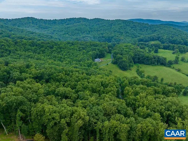 a view of a field and mountains