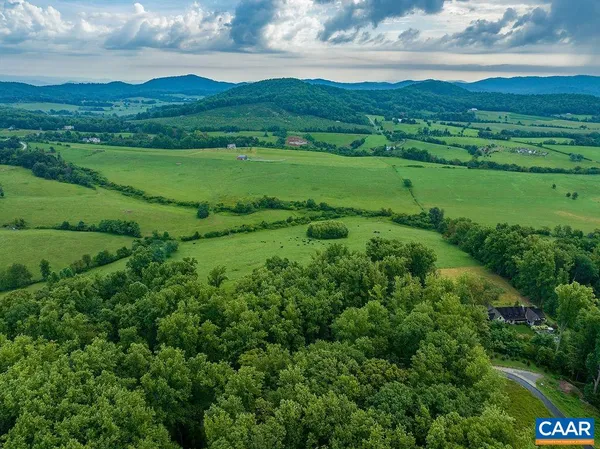 a view of grassy field with mountain
