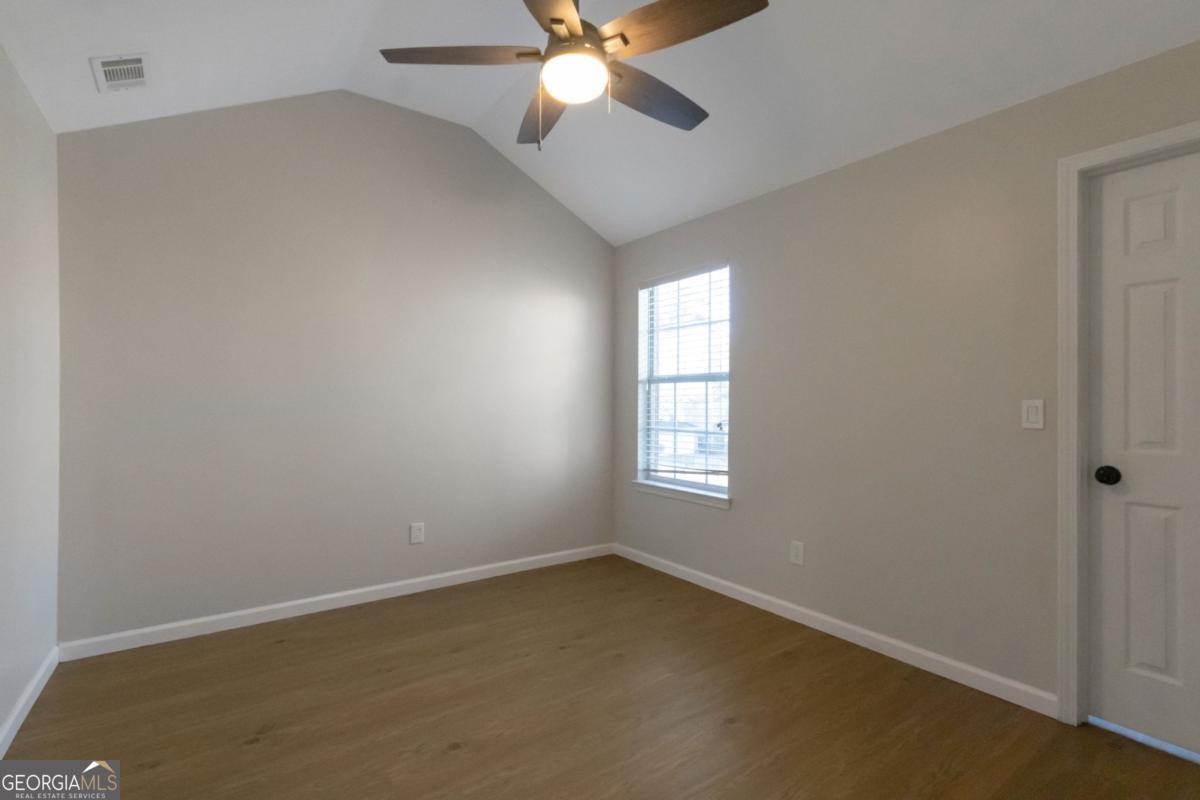 5920 Seabright Lane Atlanta, GA 30349 - Photo 14 of 18 an empty room with windows and fan
