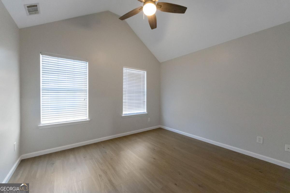 5920 Seabright Lane Atlanta, GA 30349 - Photo 15 of 18 a view of an empty room with wooden floor and a window