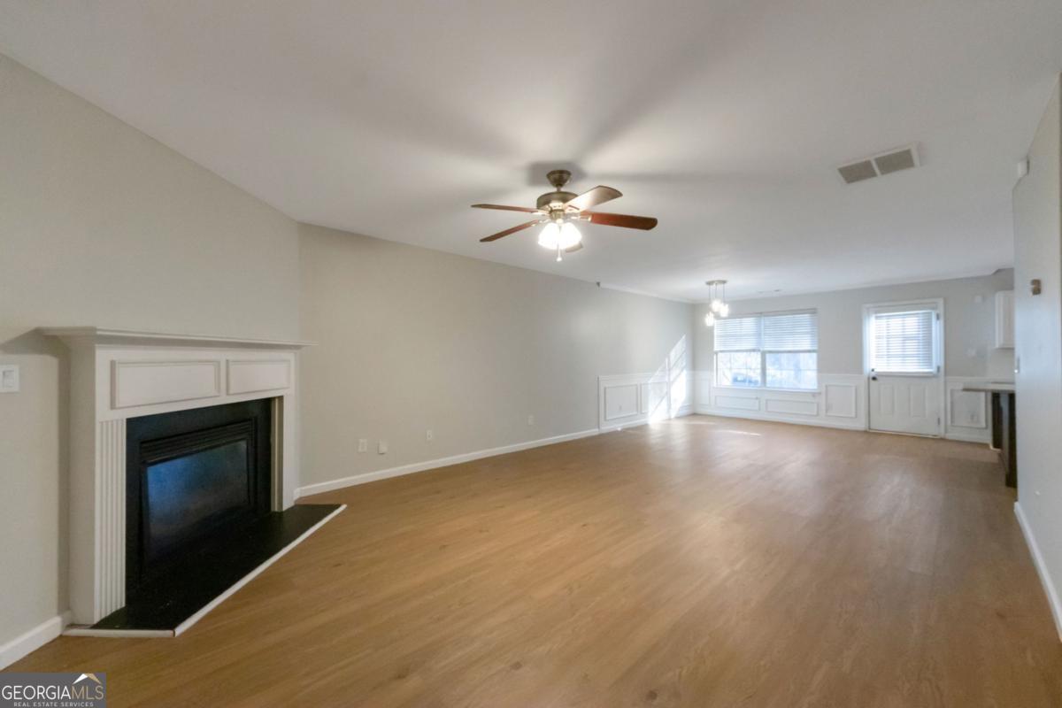5920 Seabright Lane Atlanta, GA 30349 - Photo 2 of 18 a view of an empty room with chandelier and fireplace