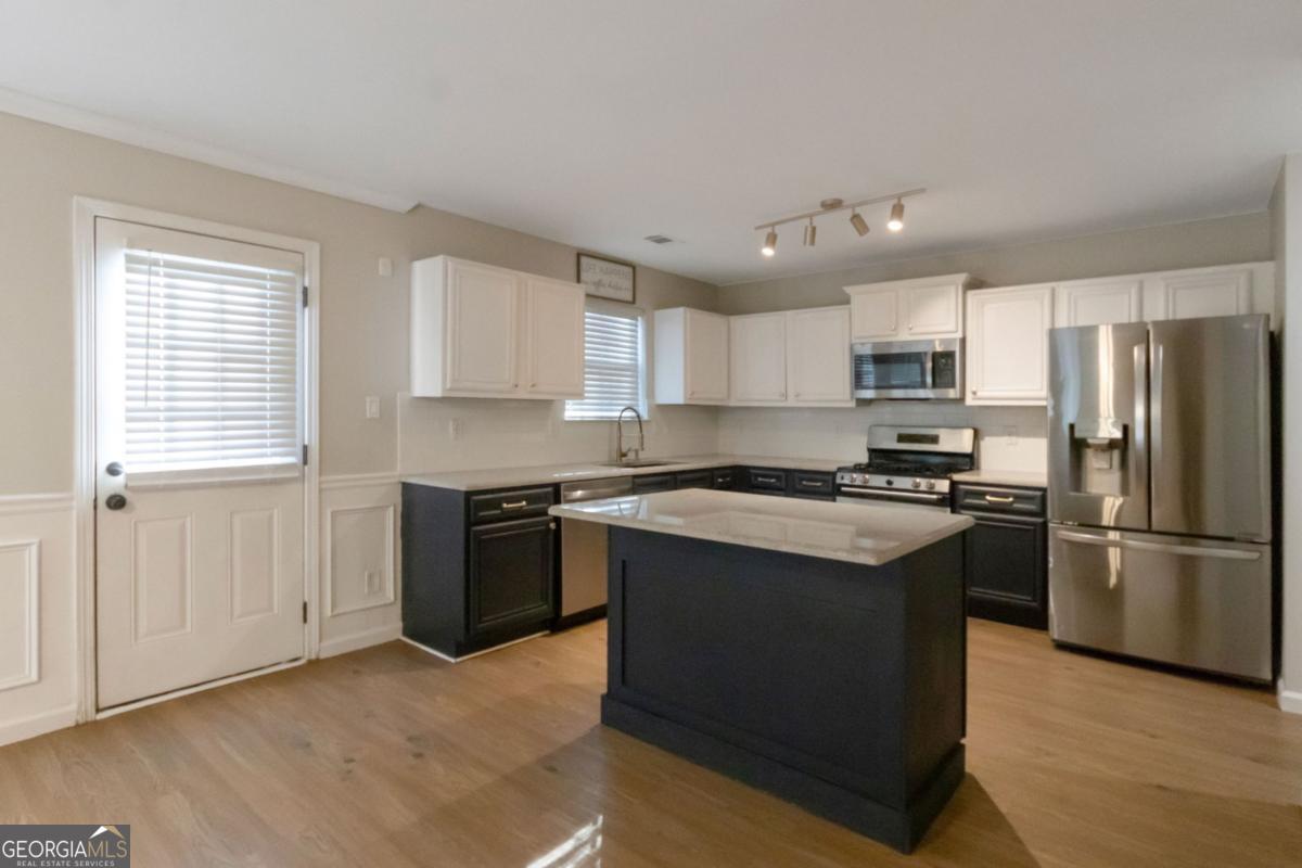 5920 Seabright Lane Atlanta, GA 30349 - Photo 3 of 18 a kitchen with a refrigerator stove and sink