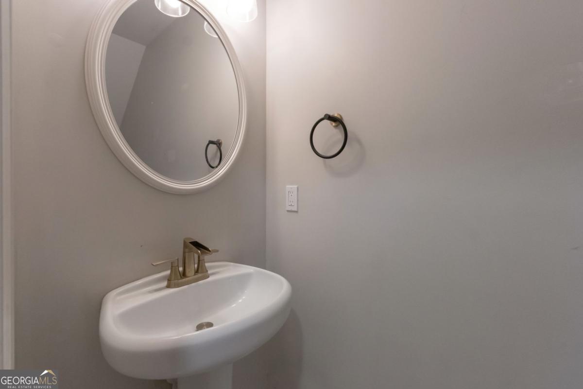 5920 Seabright Lane Atlanta, GA 30349 - Photo 6 of 18 a bathroom with a sink and mirror