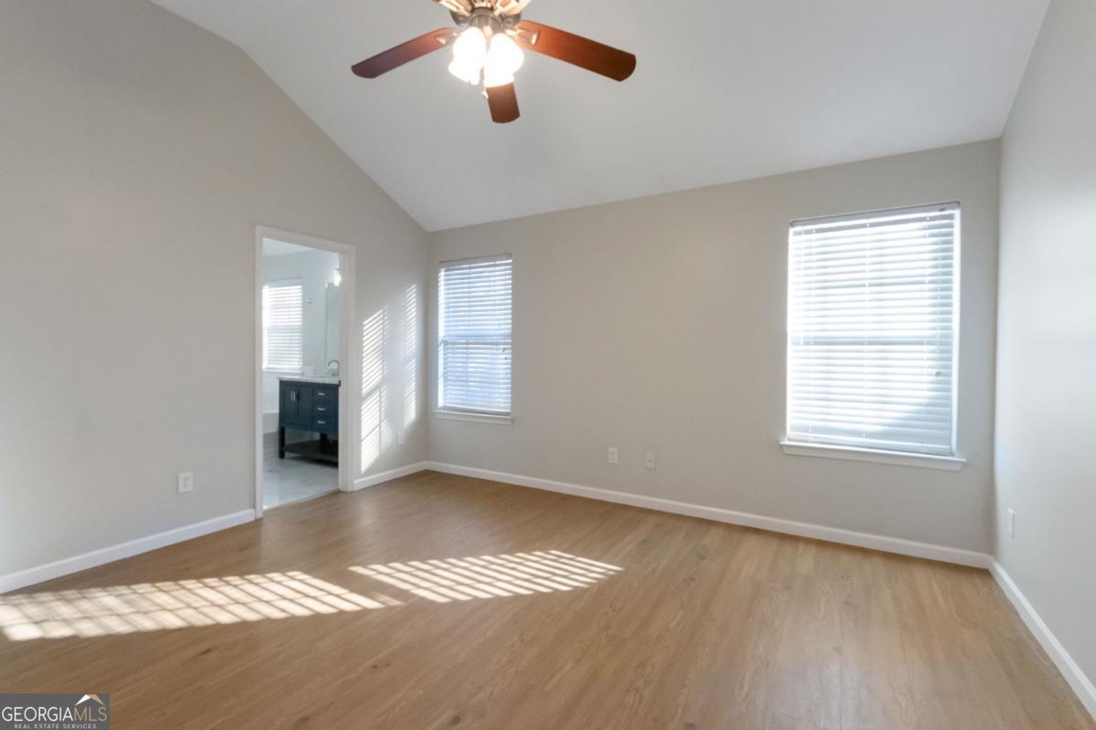 5920 Seabright Lane Atlanta, GA 30349 - Photo 7 of 18 a view of an empty room with window and wooden floor
