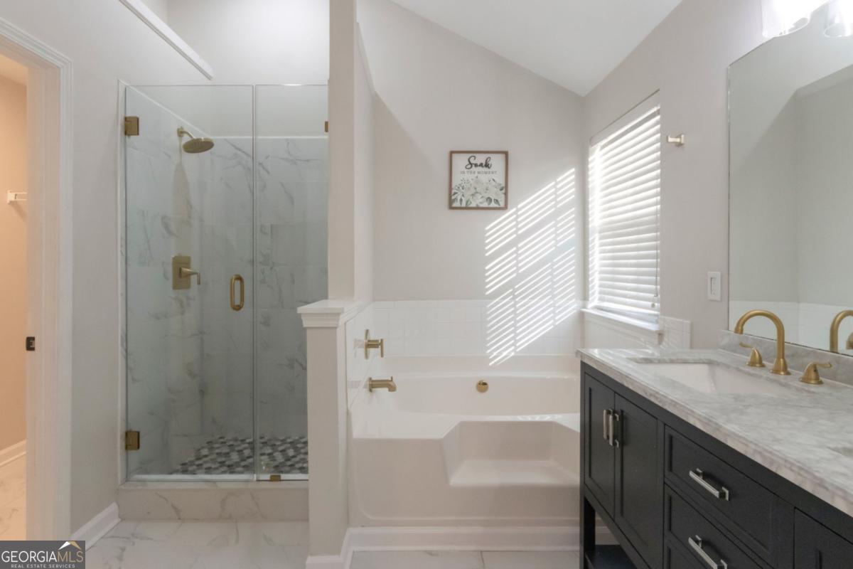 5920 Seabright Lane Atlanta, GA 30349 - Photo 9 of 18 a bathroom with a granite countertop sink and shower