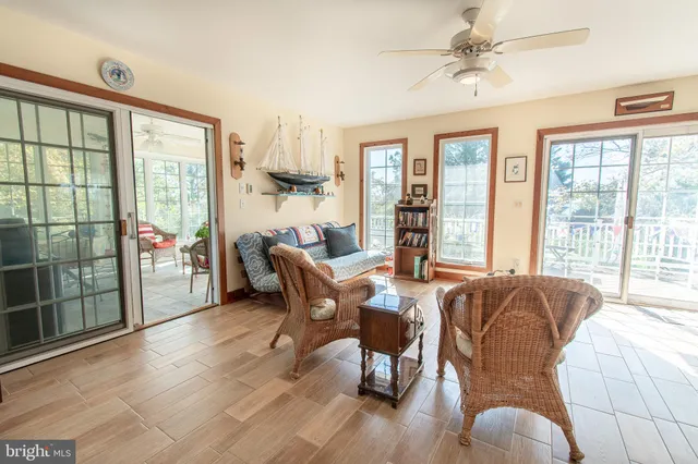 a living room with furniture and a floor to ceiling window
