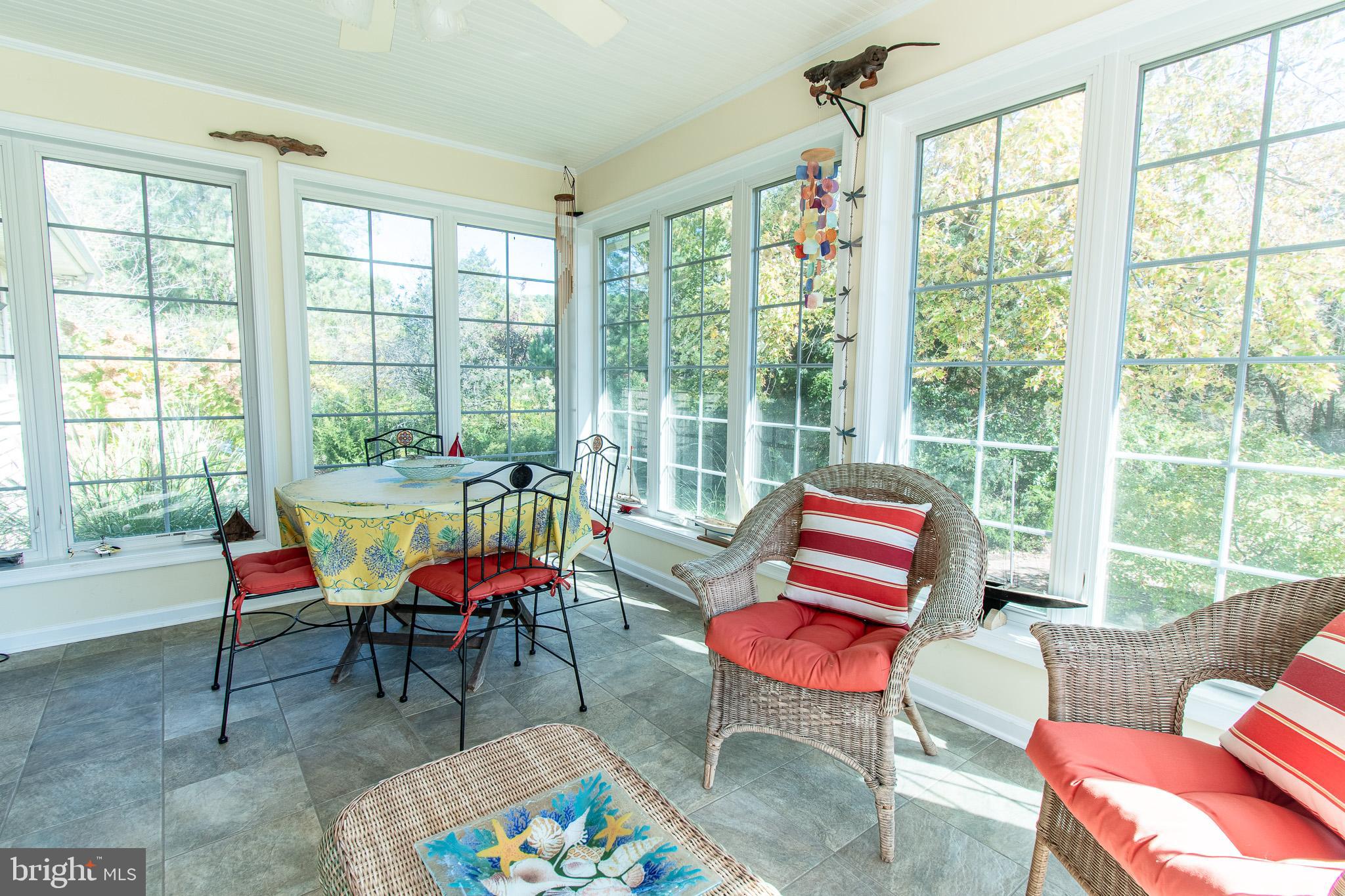 6271 Neavitt Manor Road Neavitt, MD 21652 - Photo 17 of 41 Floor to ceiling windows sunroom w/ garden views