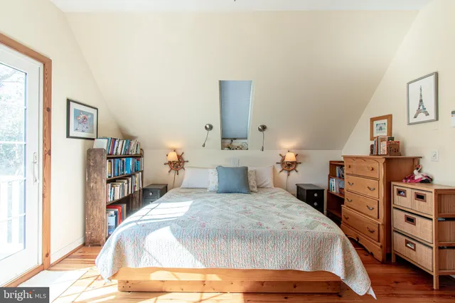 a bedroom with a bed and a book shelf