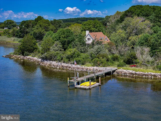 an aerial view of a house with a garden and swimming pool