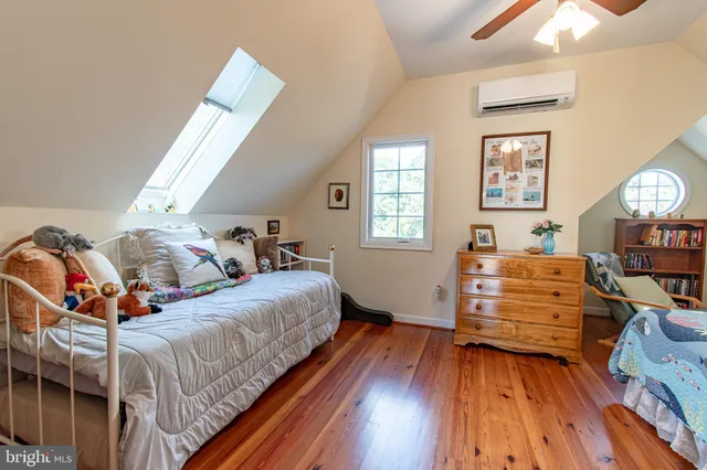 a bedroom with furniture and a wooden floor