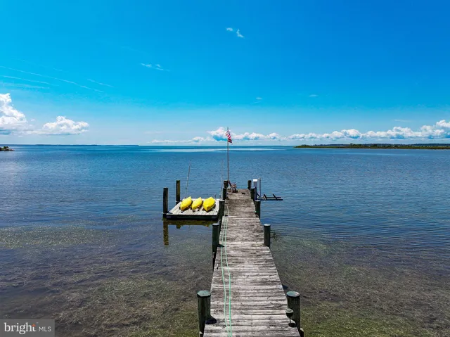 a view of a lake with two chairs