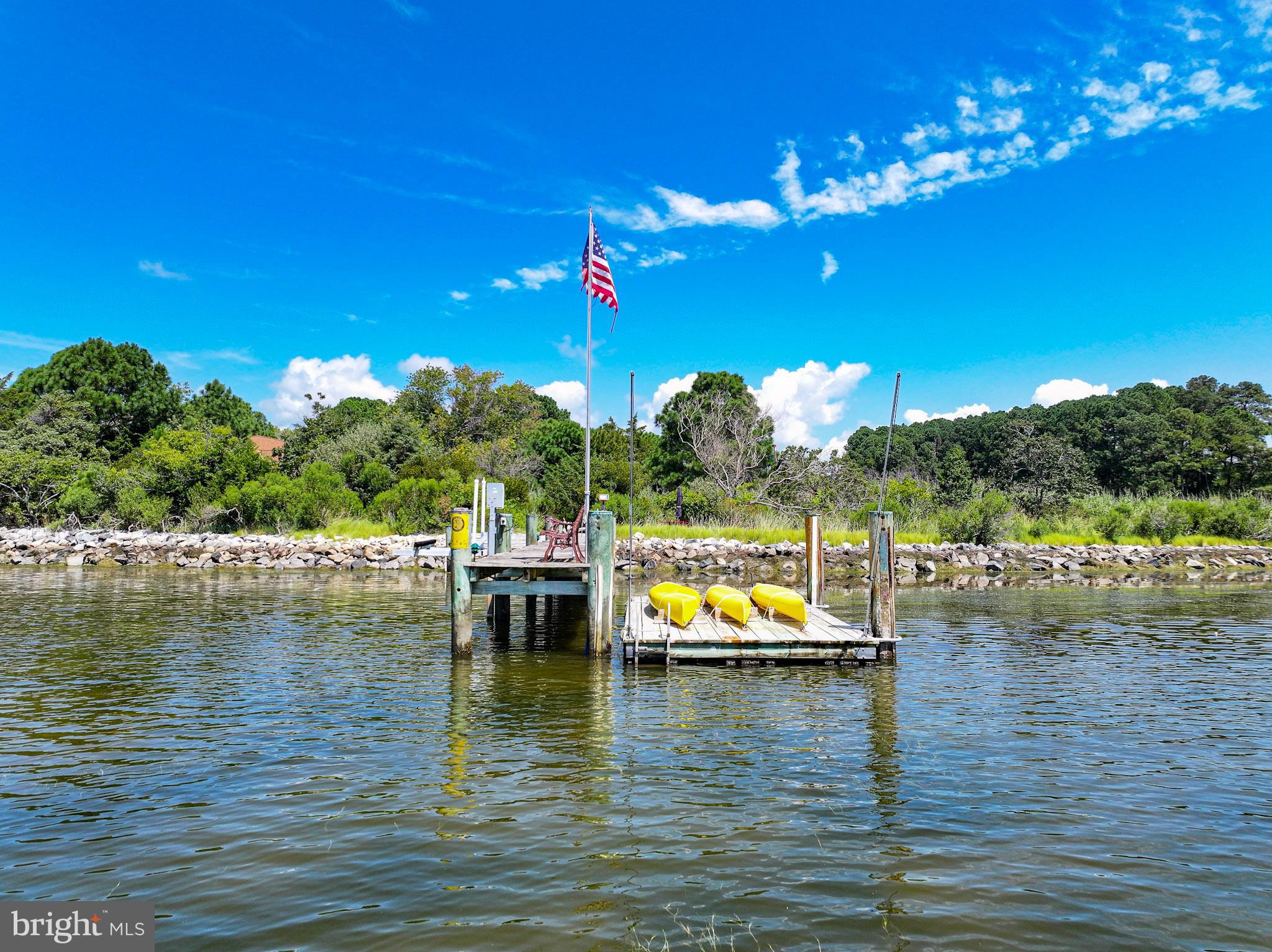 6271 Neavitt Manor Road Neavitt, MD 21652 - Photo 5 of 41 Sunny dock with kayaks and vibrant skies.