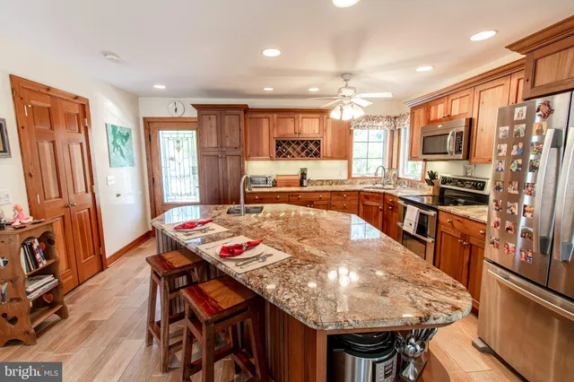 a large kitchen with a table and chairs