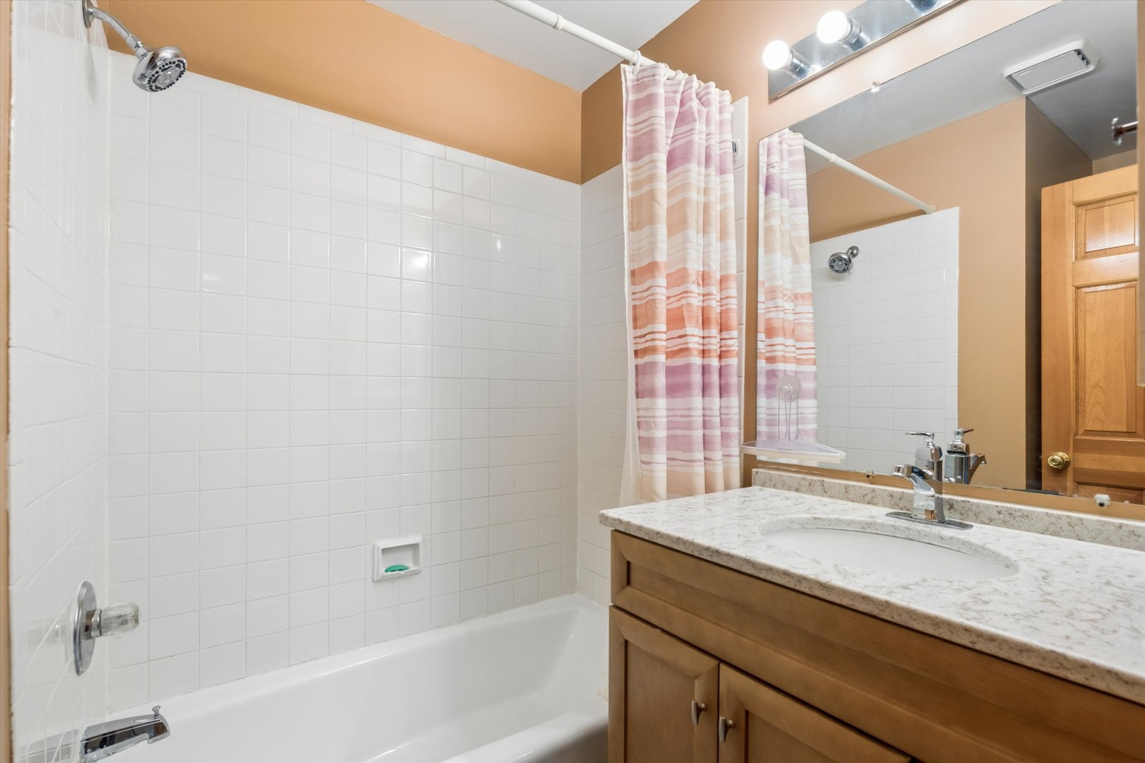 2142 North Summit Street Wheaton, IL 60187 - Photo 20 of 35 a bathroom with a granite countertop sink a mirror and a bathtub