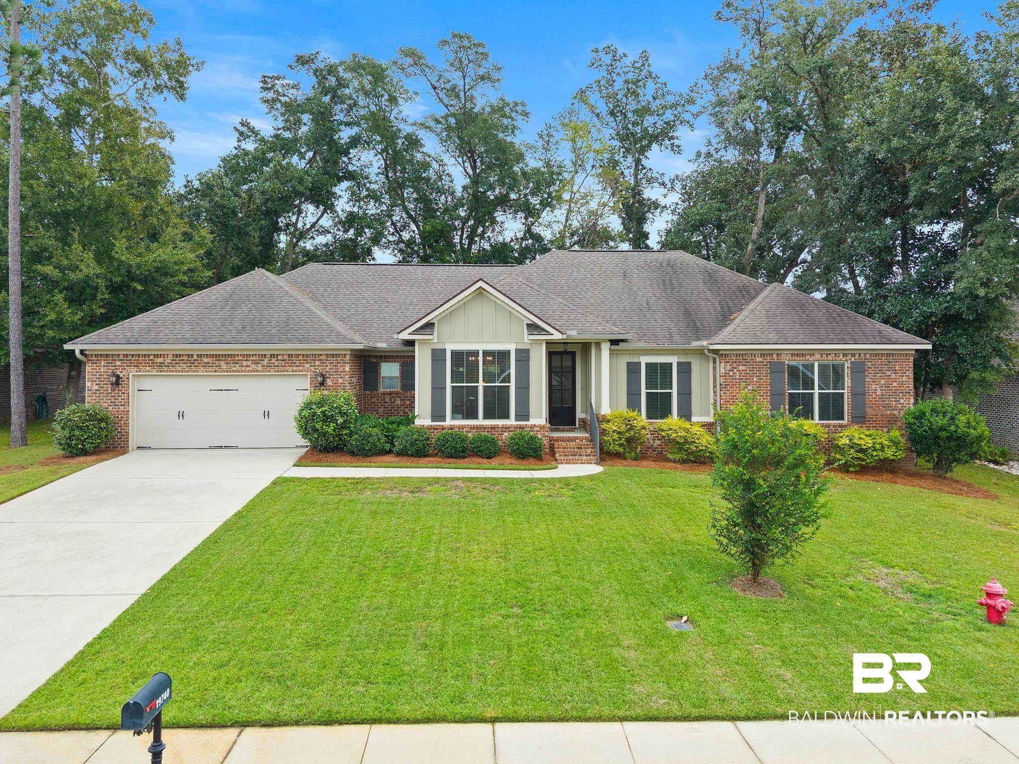 19740 Bunker Loop Fairhope, AL 36532 - Photo 1 of 33 Ranch-style house featuring driveway, a garage, a front lawn, roof with shingles, and brick siding