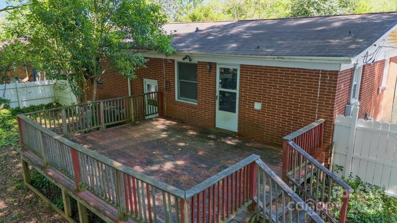 1127 Clanton Road Charlotte, NC 28217 - Photo 15 of 25 a view of house with wooden deck and backyard
