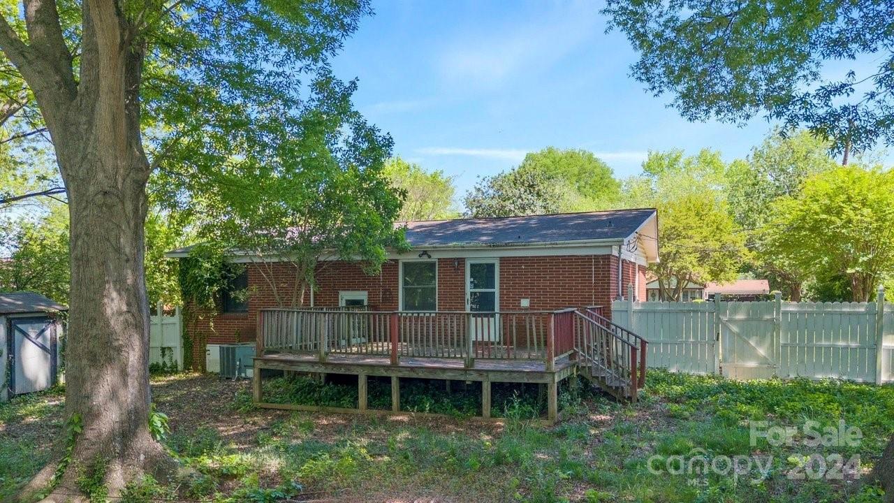 1127 Clanton Road Charlotte, NC 28217 - Photo 17 of 25 a backyard of a house with table and chairs