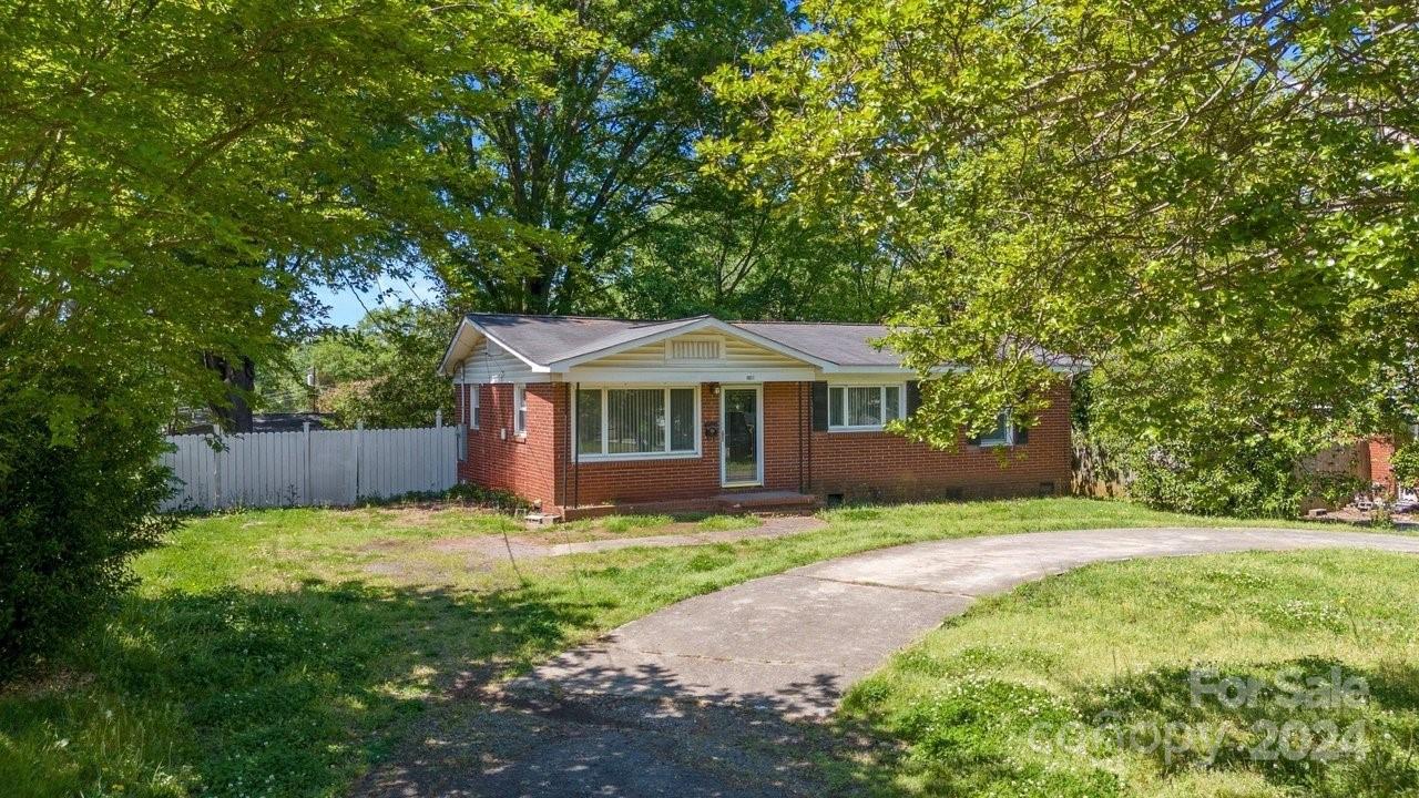 1127 Clanton Road Charlotte, NC 28217 - Photo 20 of 25 a front view of a house with yard and green space