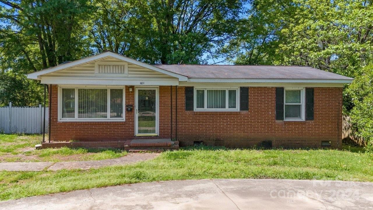 1127 Clanton Road Charlotte, NC 28217 - Photo 2 of 25 a front view of a house with a garden