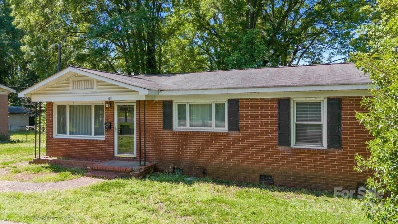 1127 Clanton Road Charlotte, NC 28217 - Photo 21 of 25 a front view of a house with a garden