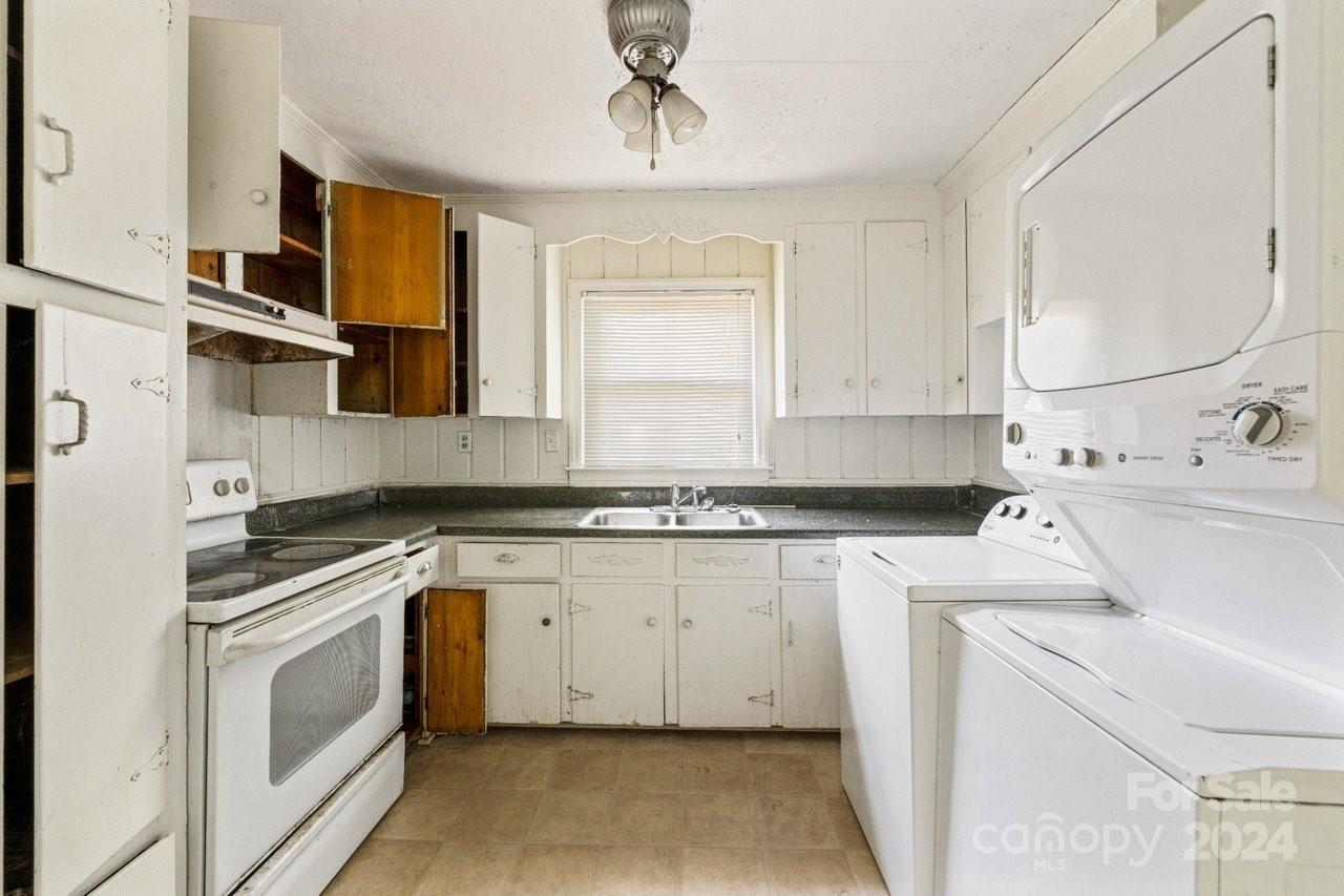 1127 Clanton Road Charlotte, NC 28217 - Photo 8 of 25 a kitchen with a stove cabinets and a sink