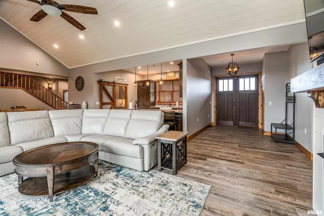 a kitchen with granite countertop a stove a sink a dining table and chairs