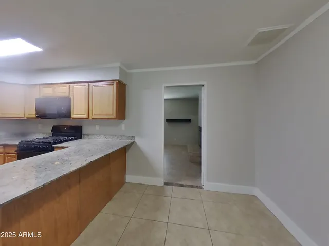 a kitchen with a sink a stove and cabinets