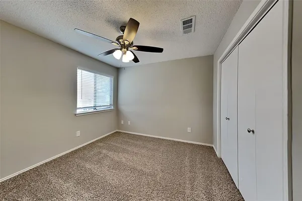 a view of room with a ceiling fan and window