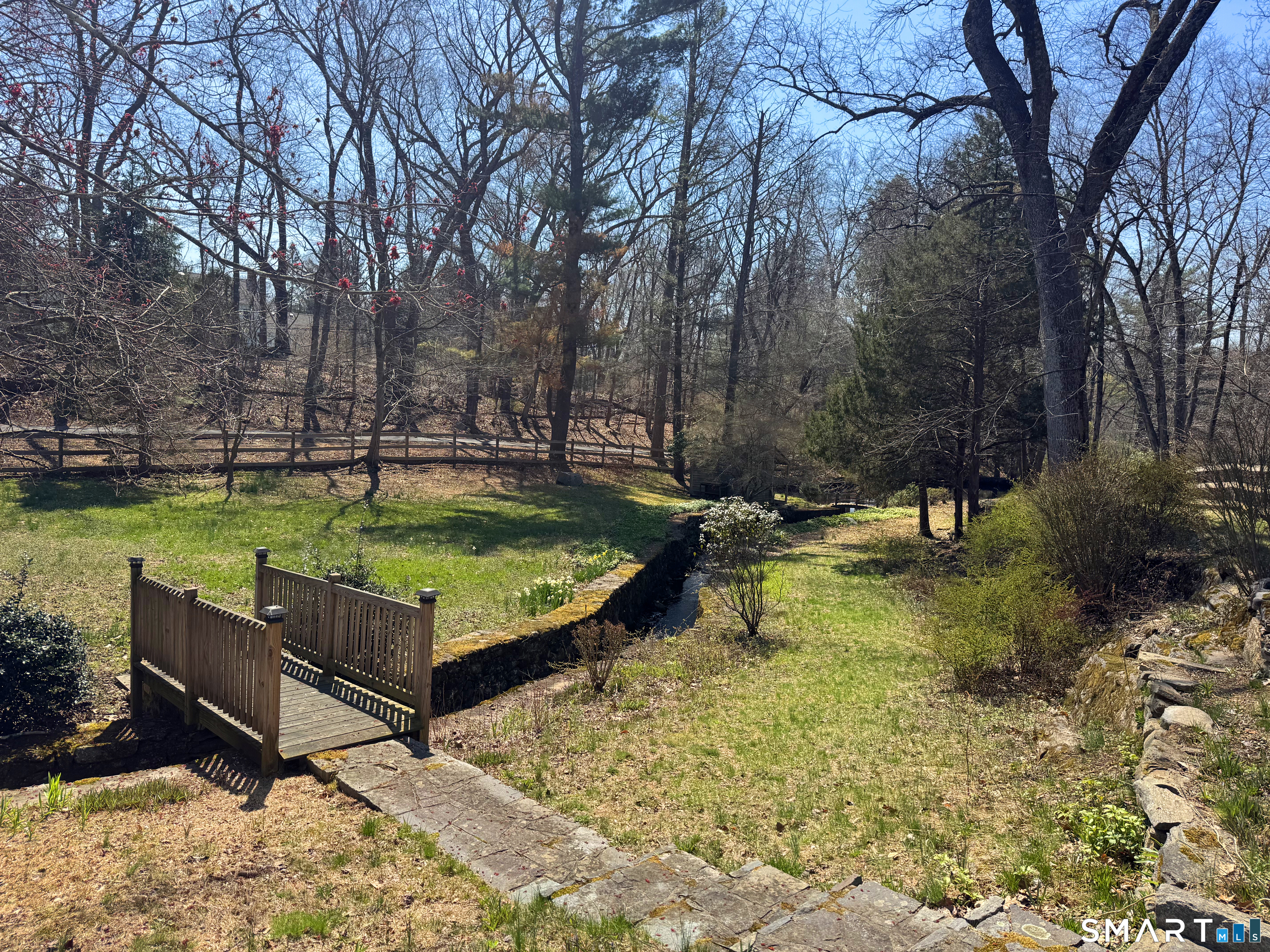 143 Roseville Road Westport, CT 06880 - Photo 14 of 14 a view of a swimming pool with a bench and trees