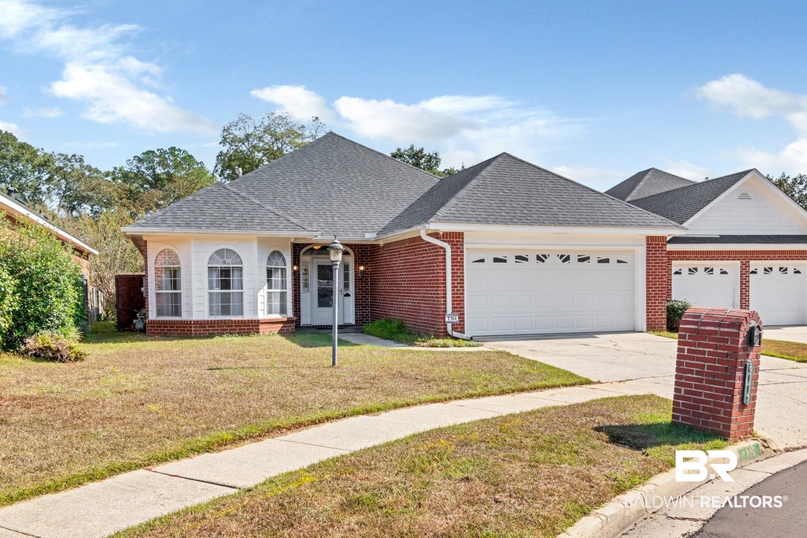 6117 Lennox Place Mobile, AL 36693 - Photo 34 of 39 Ranch-style home featuring a garage, a front yard, roof with shingles, brick siding, and concrete driveway