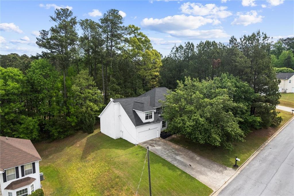3234 Mineral Ridge Lane Stone Mountain, GA 30087 - Photo 48 of 55 an aerial view of a house with swimming pool and garden