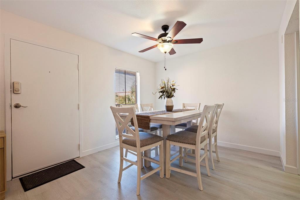 8911 Blind Pass Road, Unit 319 St. Pete Beach, FL 33706 - Photo 11 of 29 a dining room with furniture and window