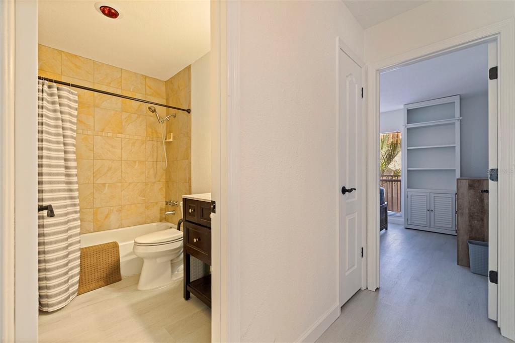 8911 Blind Pass Road, Unit 319 St. Pete Beach, FL 33706 - Photo 16 of 29 a bathroom with a sink toilet and shower