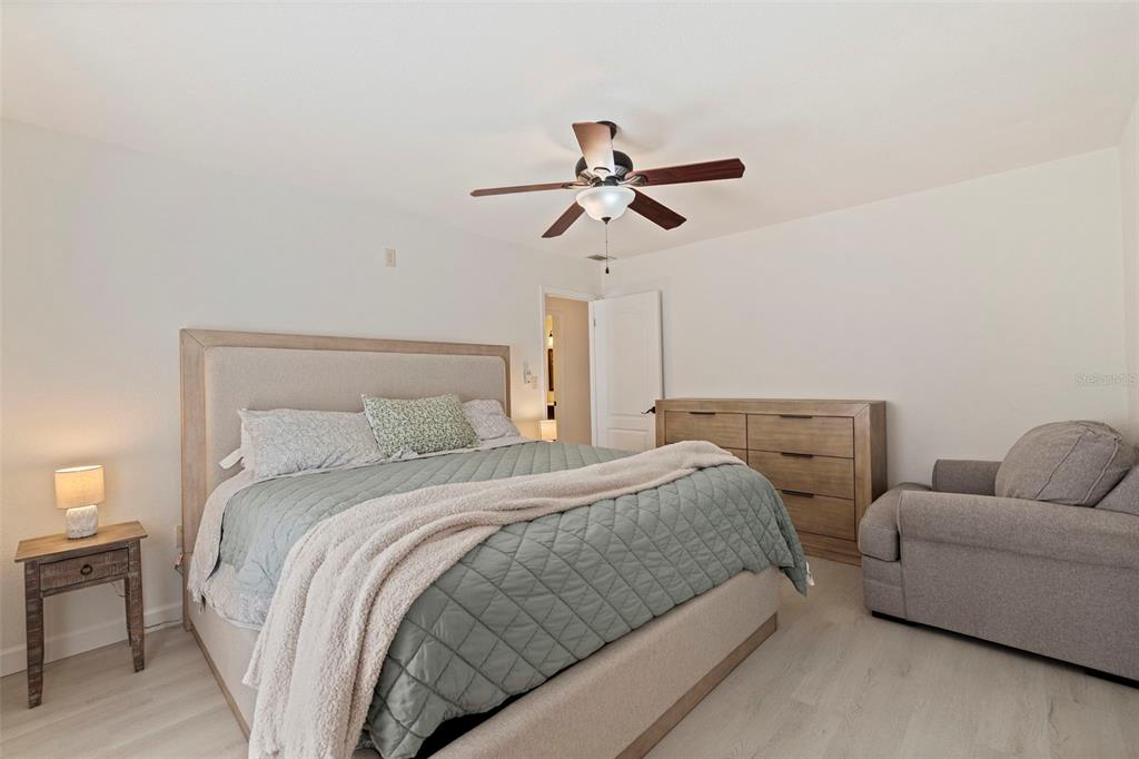 8911 Blind Pass Road, Unit 319 St. Pete Beach, FL 33706 - Photo 18 of 29 a bed room with a bed and a couch