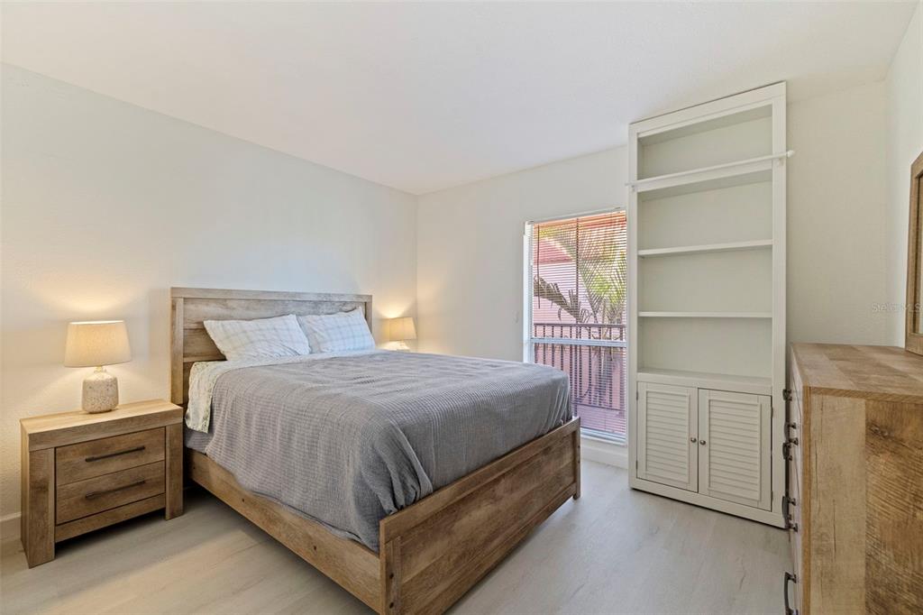 8911 Blind Pass Road, Unit 319 St. Pete Beach, FL 33706 - Photo 21 of 29 a bedroom with a bed and cabinet