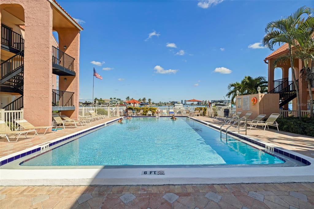 8911 Blind Pass Road, Unit 319 St. Pete Beach, FL 33706 - Photo 27 of 29 a view of a swimming pool with outdoor seating