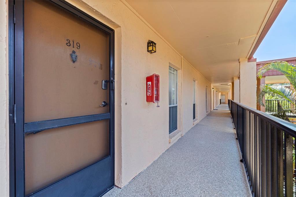 8911 Blind Pass Road, Unit 319 St. Pete Beach, FL 33706 - Photo 3 of 29 a view of hallway with wooden floor