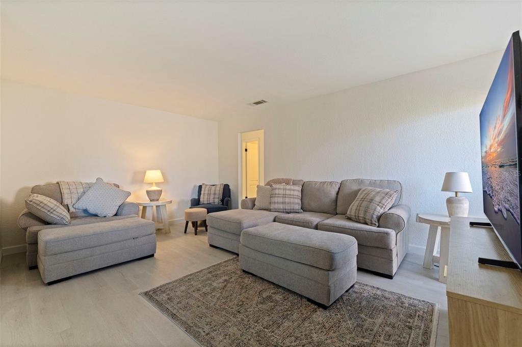 8911 Blind Pass Road, Unit 319 St. Pete Beach, FL 33706 - Photo 6 of 29 a living room with furniture and a couch