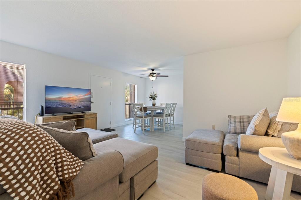 8911 Blind Pass Road, Unit 319 St. Pete Beach, FL 33706 - Photo 9 of 29 a living room with furniture a ceiling fan and a window