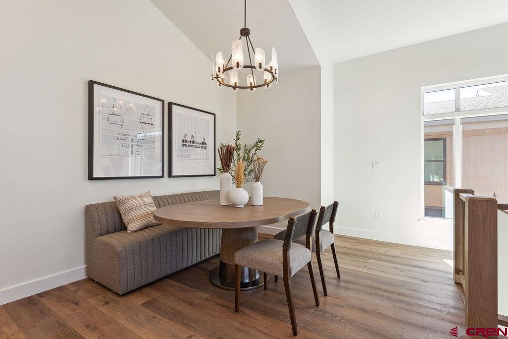 185 Riverfront Lane, Unit D1 B Ridgway, CO 81432 - Photo 13 of 35 a view of a dining room with furniture wooden floor and chandelier