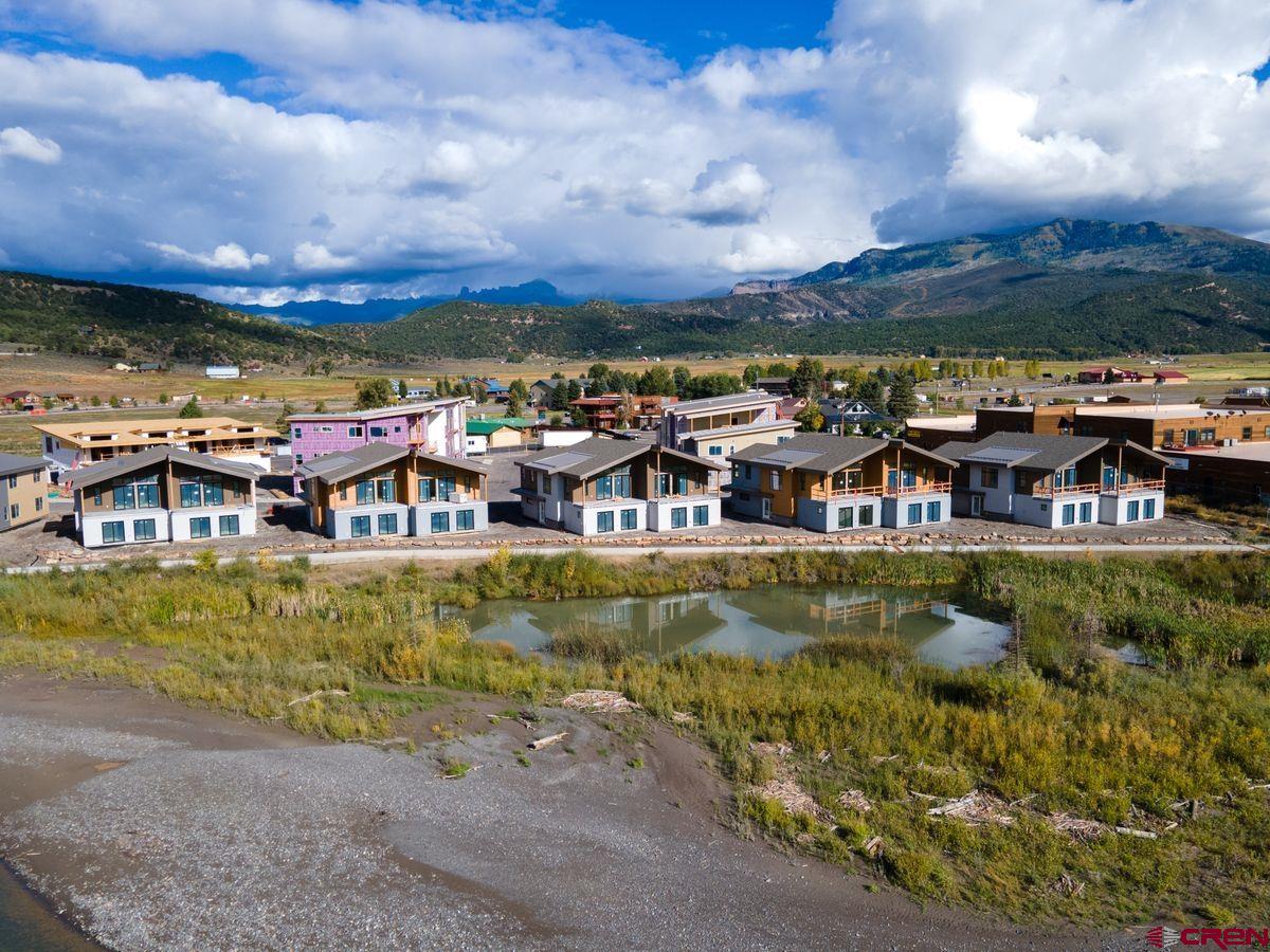 185 Riverfront Lane, Unit D1 B Ridgway, CO 81432 - Photo 30 of 35 a view of a lake with a house in the background